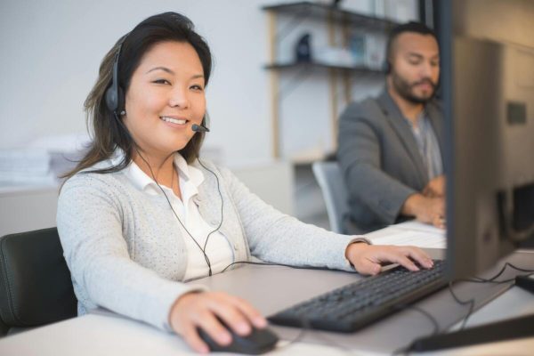 Call center agents handling customer inquiries supported by an automated response system