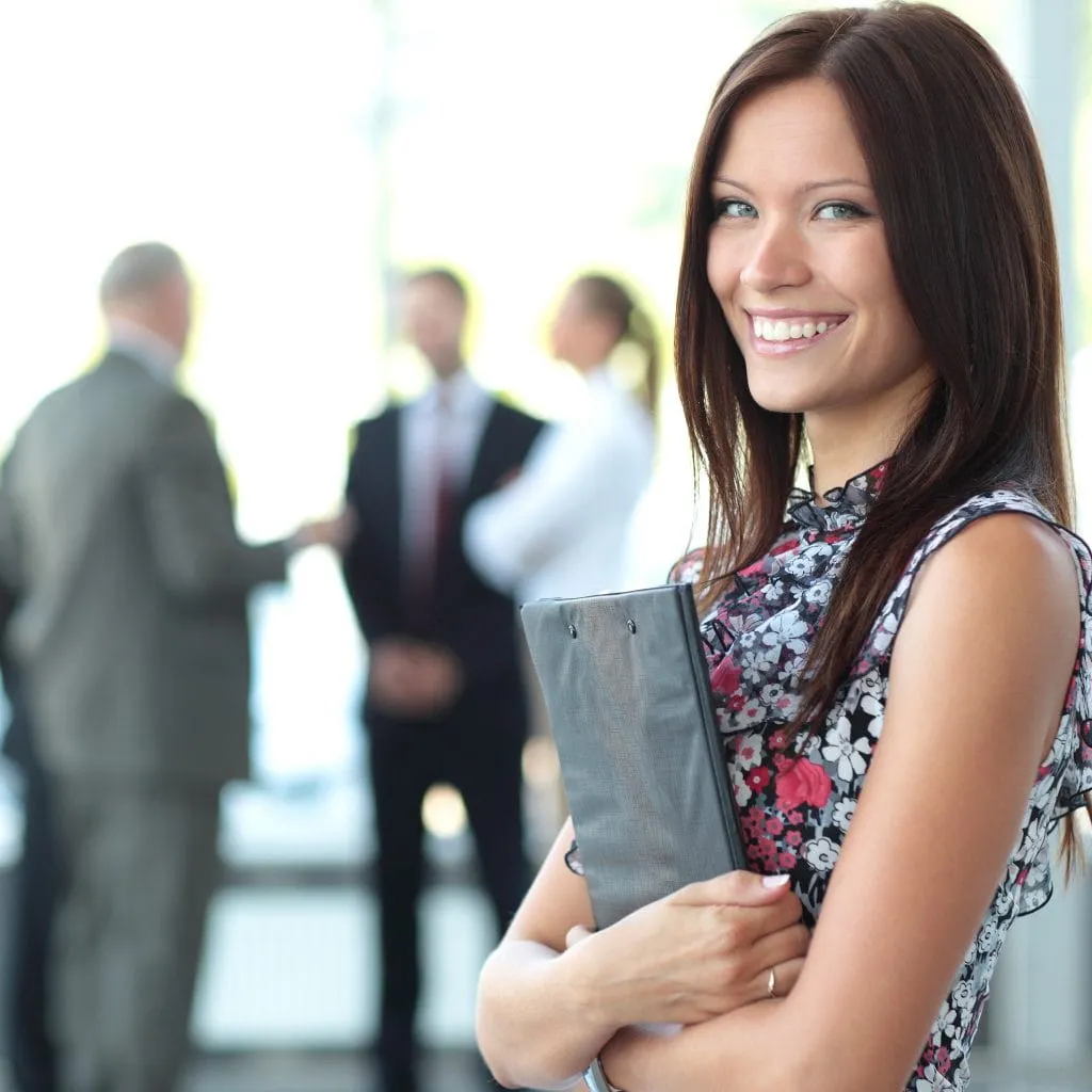 Professional carrying a portfolio in a modern business office